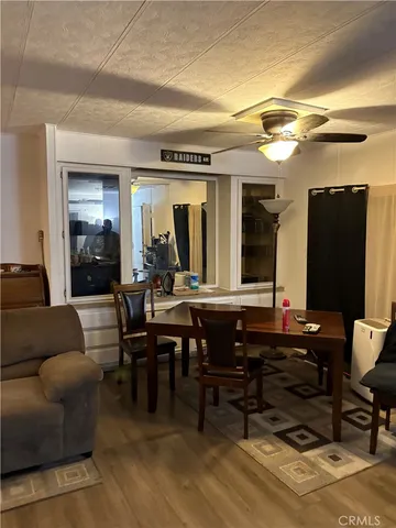 a living room with furniture a piano and a flat screen tv