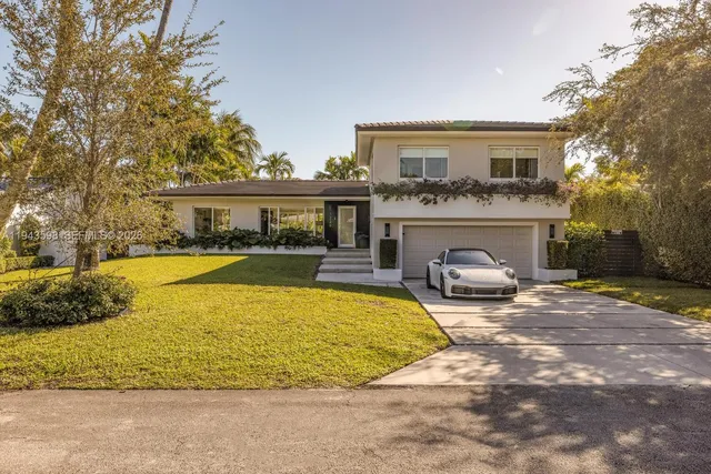 a view of a swimming pool with a patio and plants