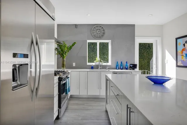 a bathroom with a sink a shower and a mirror