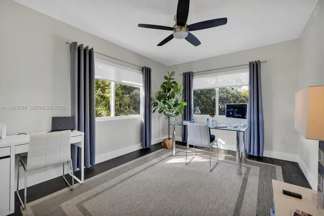 a view of a house with backyard and a tree