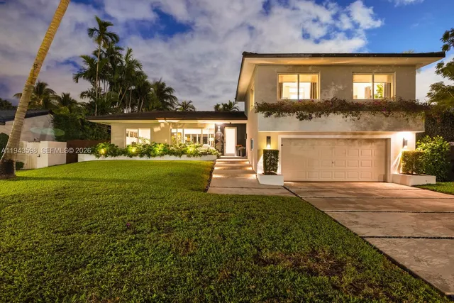 a aerial view of a house with a yard and potted plants