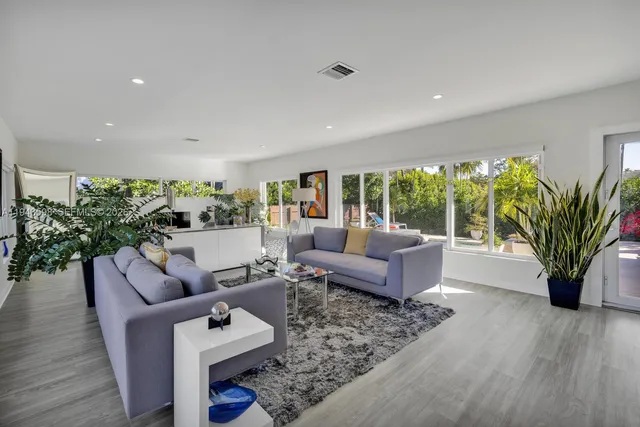 a front view of a house with a garden and yard