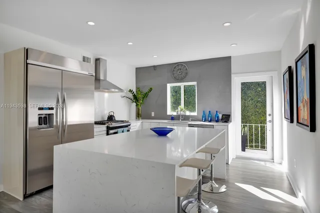 a view of a house with swimming pool and sitting area