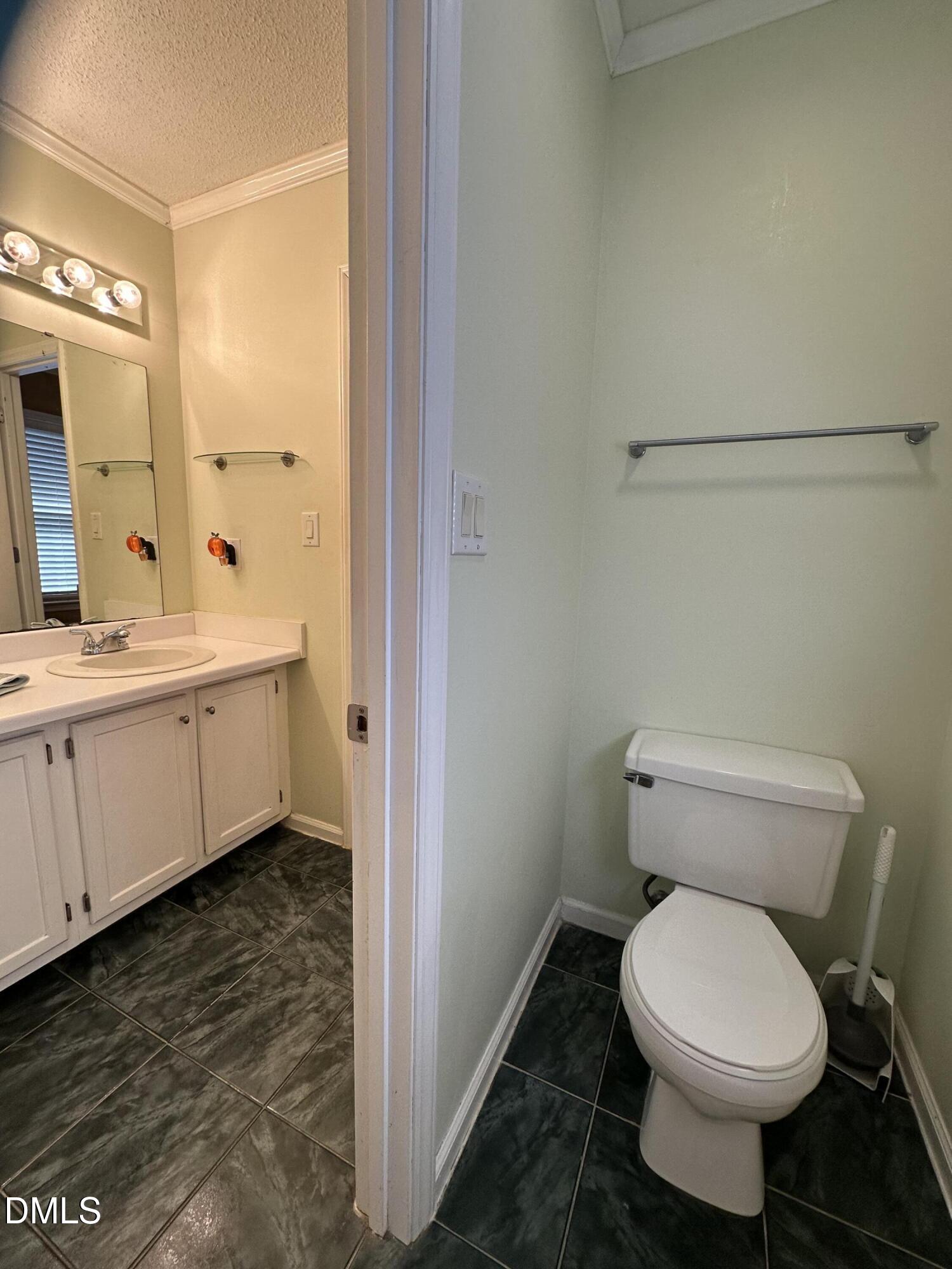 2301 Ruddy Road Raleigh, NC 27616 - Photo 11 of 17 a bathroom with a toilet sink and mirror