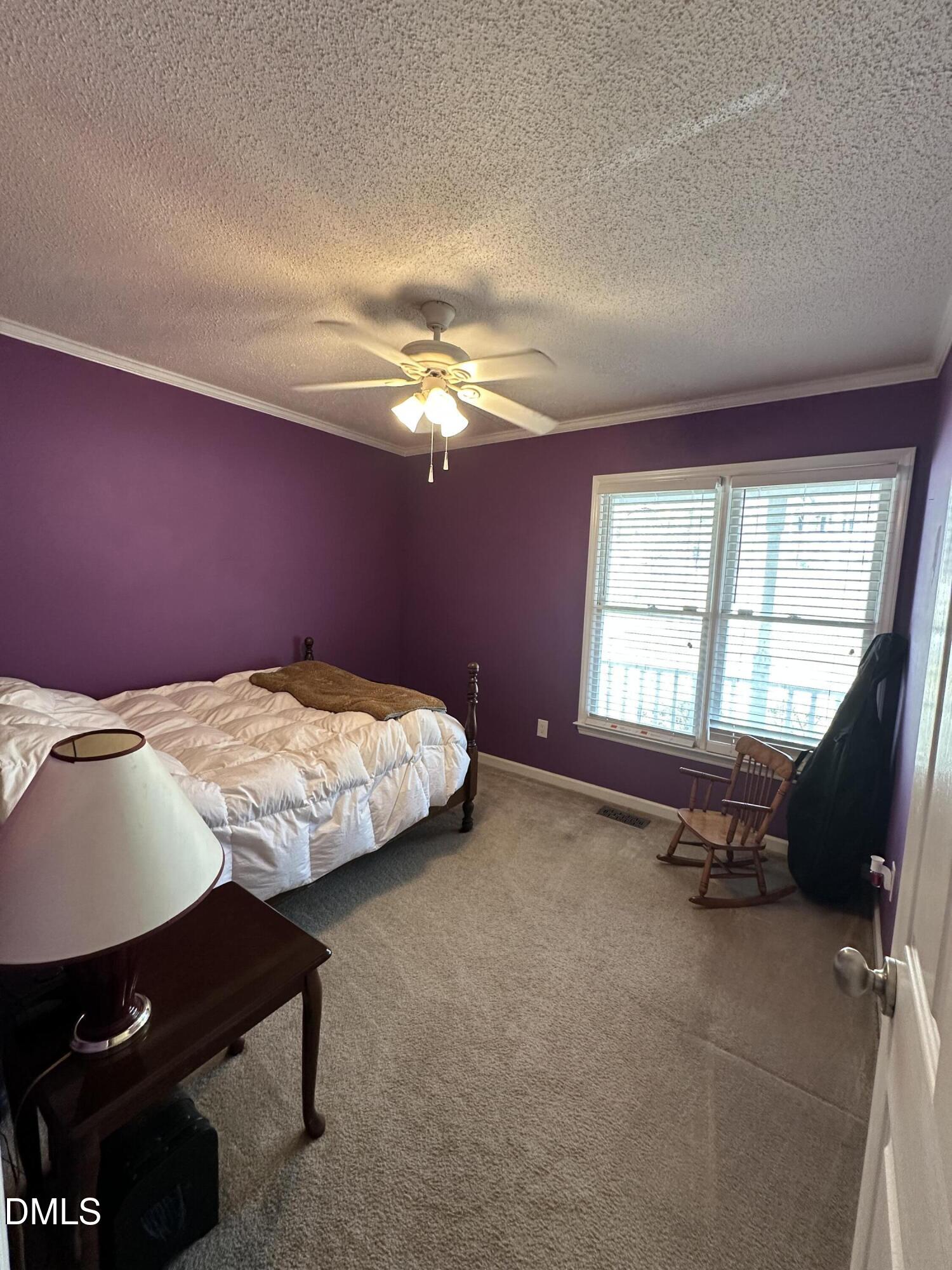 2301 Ruddy Road Raleigh, NC 27616 - Photo 12 of 17 a bed sitting in a bedroom next to a window