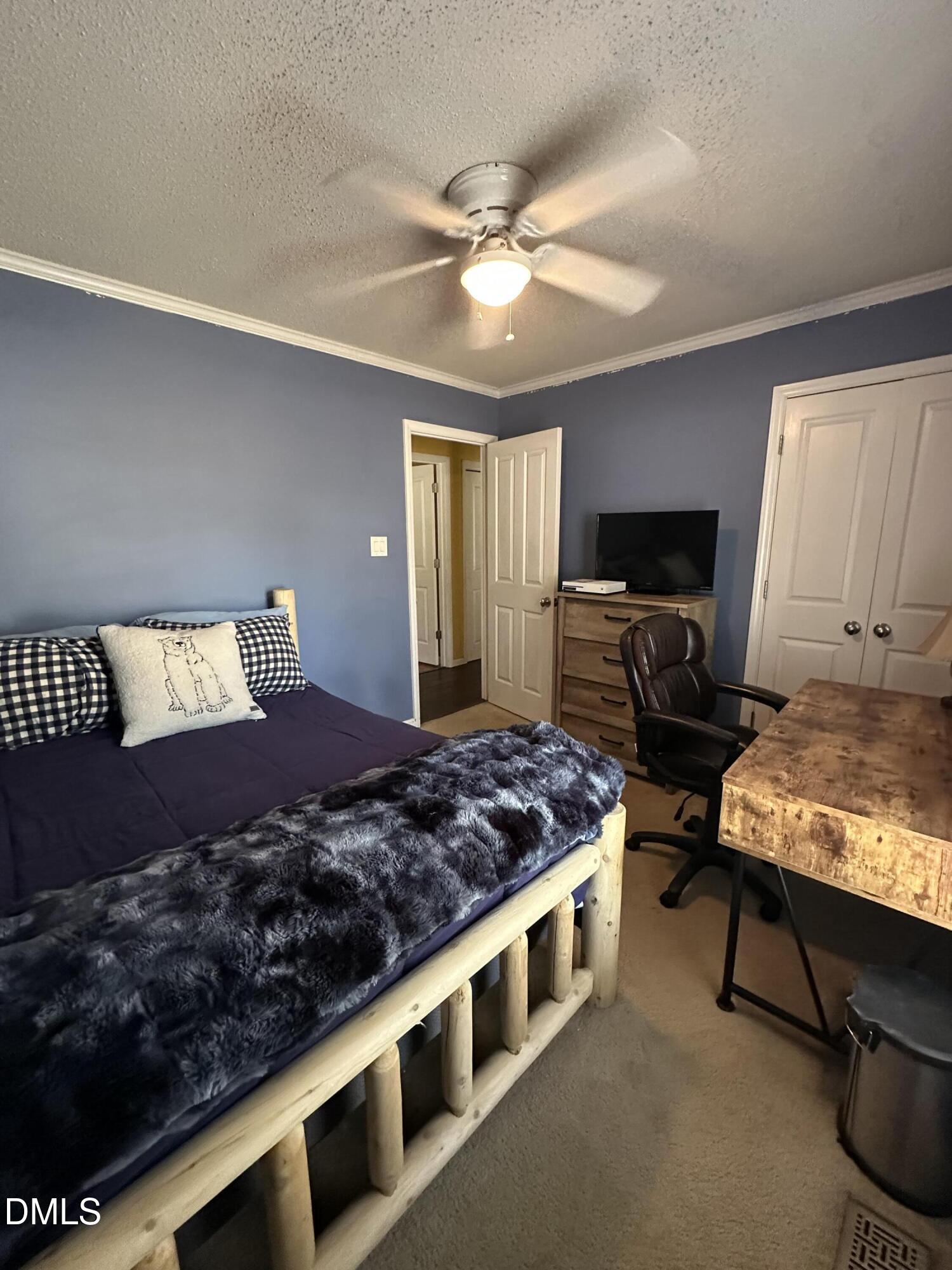 2301 Ruddy Road Raleigh, NC 27616 - Photo 13 of 17 a bed room with a bed furniture and a flat screen tv