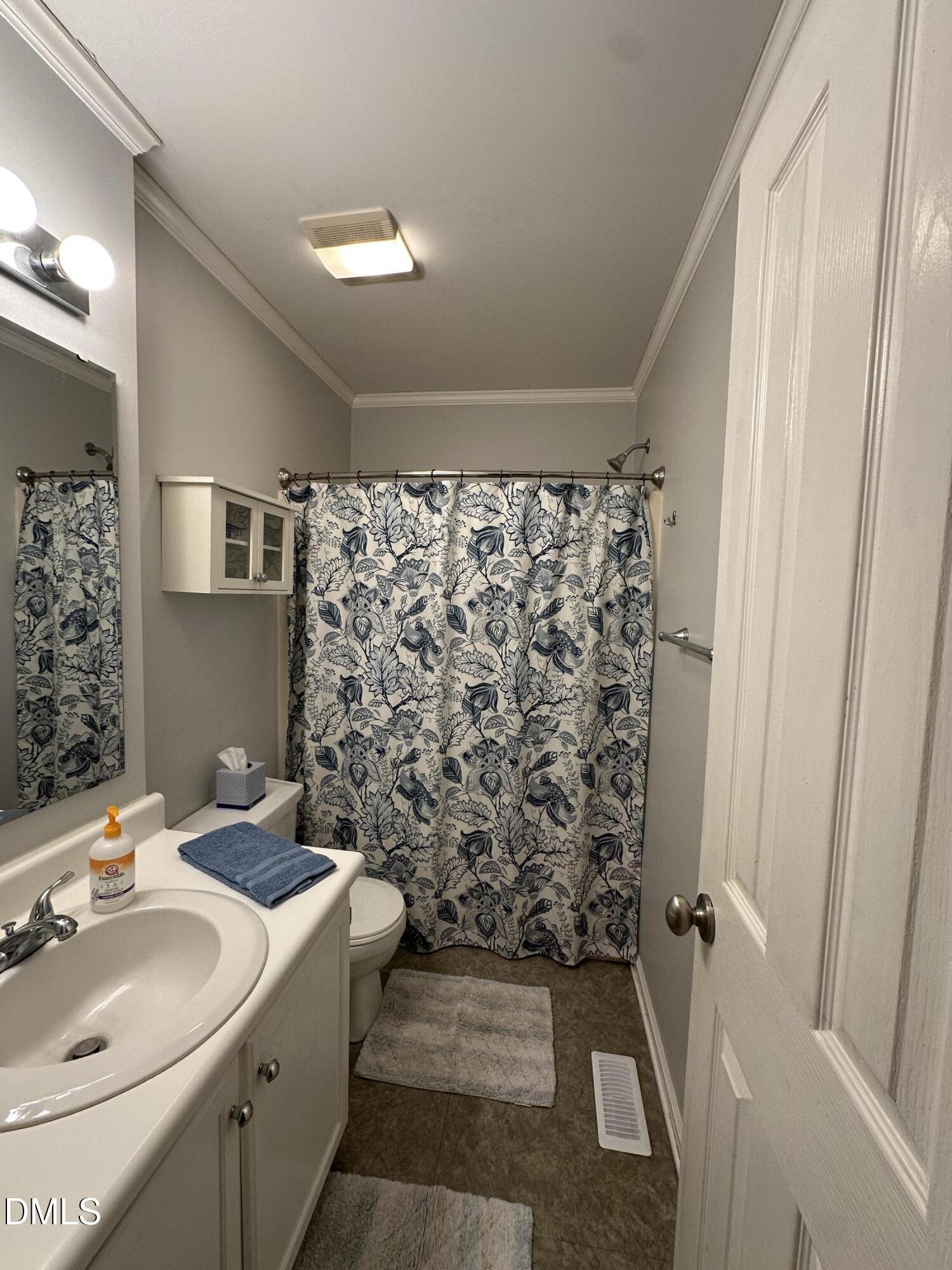 2301 Ruddy Road Raleigh, NC 27616 - Photo 14 of 17 a bathroom with a sink toilet and shower