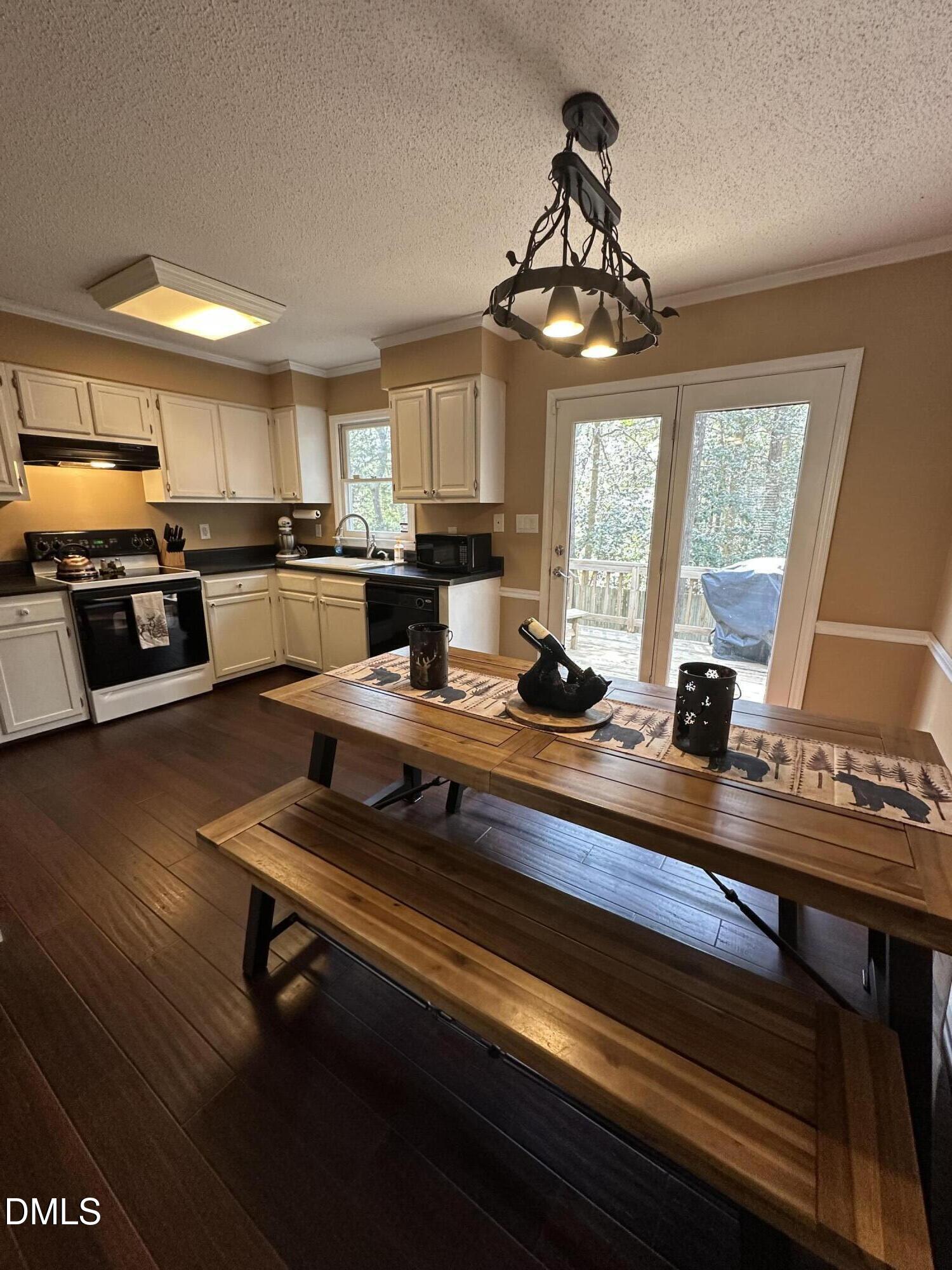 2301 Ruddy Road Raleigh, NC 27616 - Photo 5 of 17 a kitchen with a counter appliances cabinets and a ceiling fan