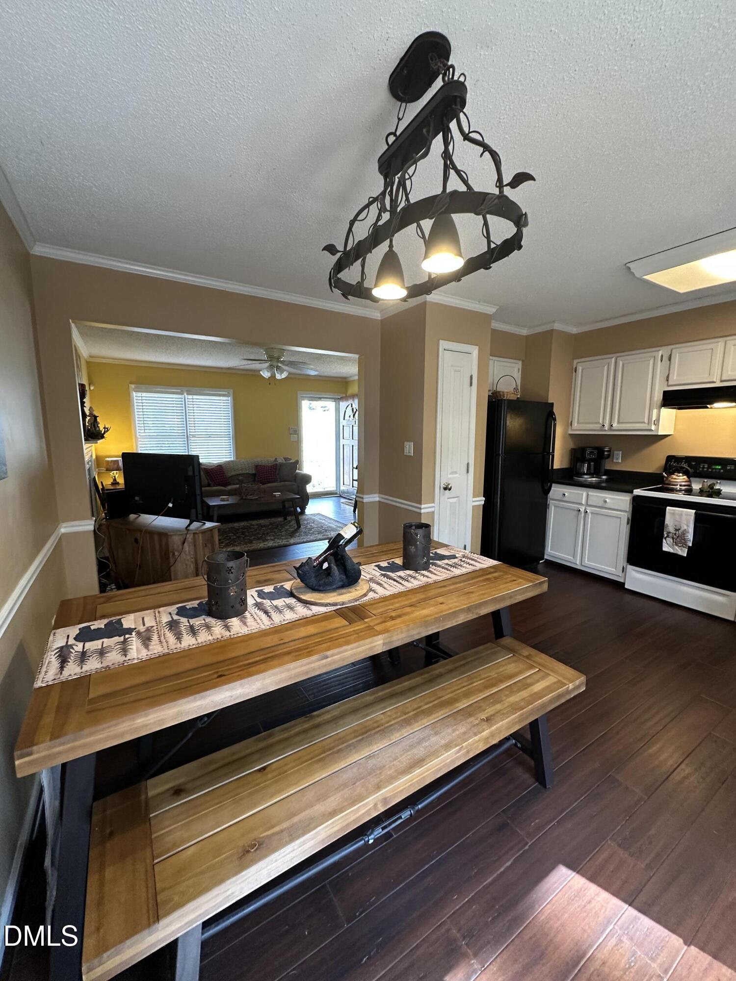2301 Ruddy Road Raleigh, NC 27616 - Photo 6 of 17 a view of a room with kitchen island stainless steel appliances wooden floor and window
