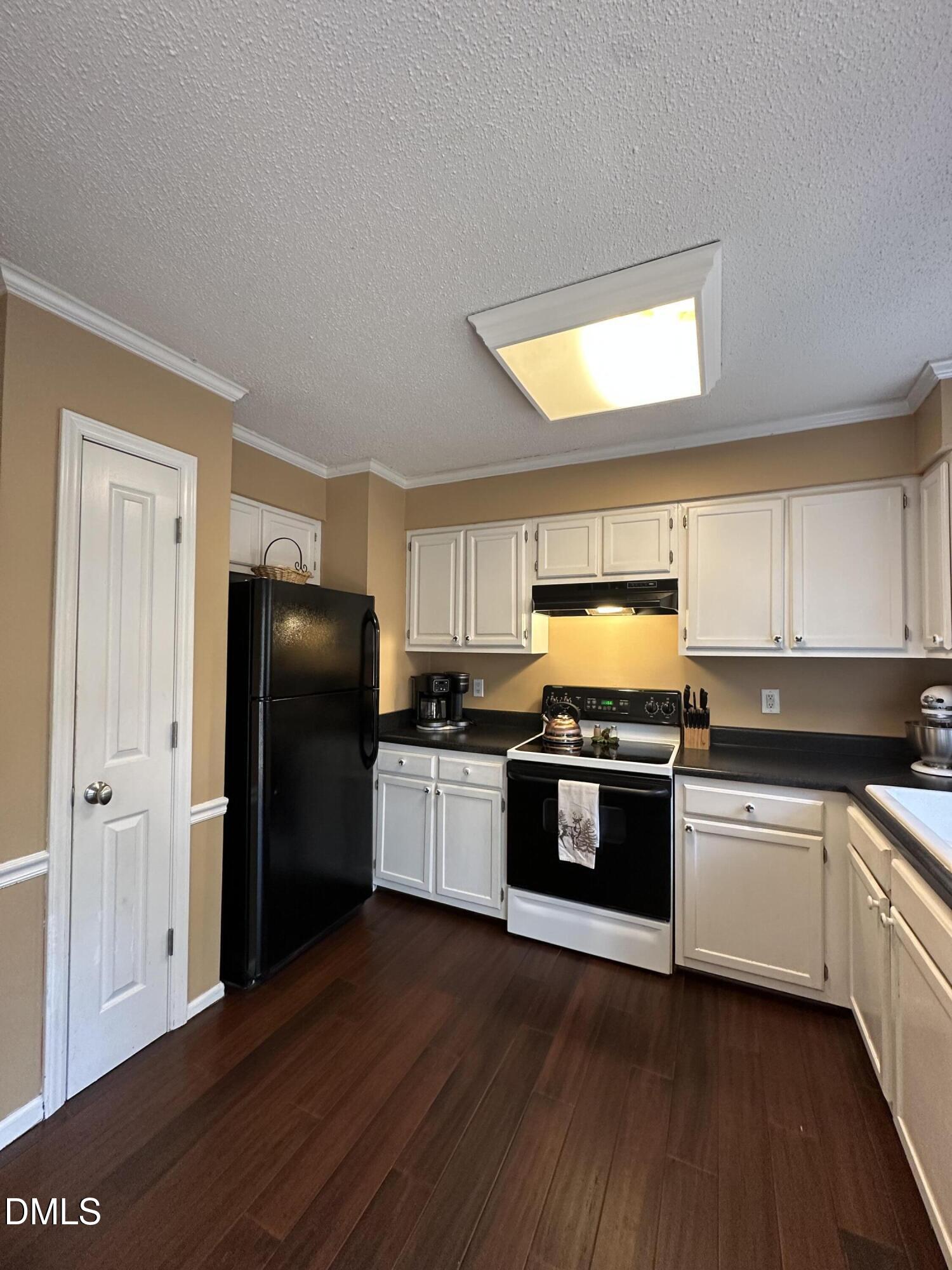 2301 Ruddy Road Raleigh, NC 27616 - Photo 7 of 17 a kitchen with a stove and a refrigerator