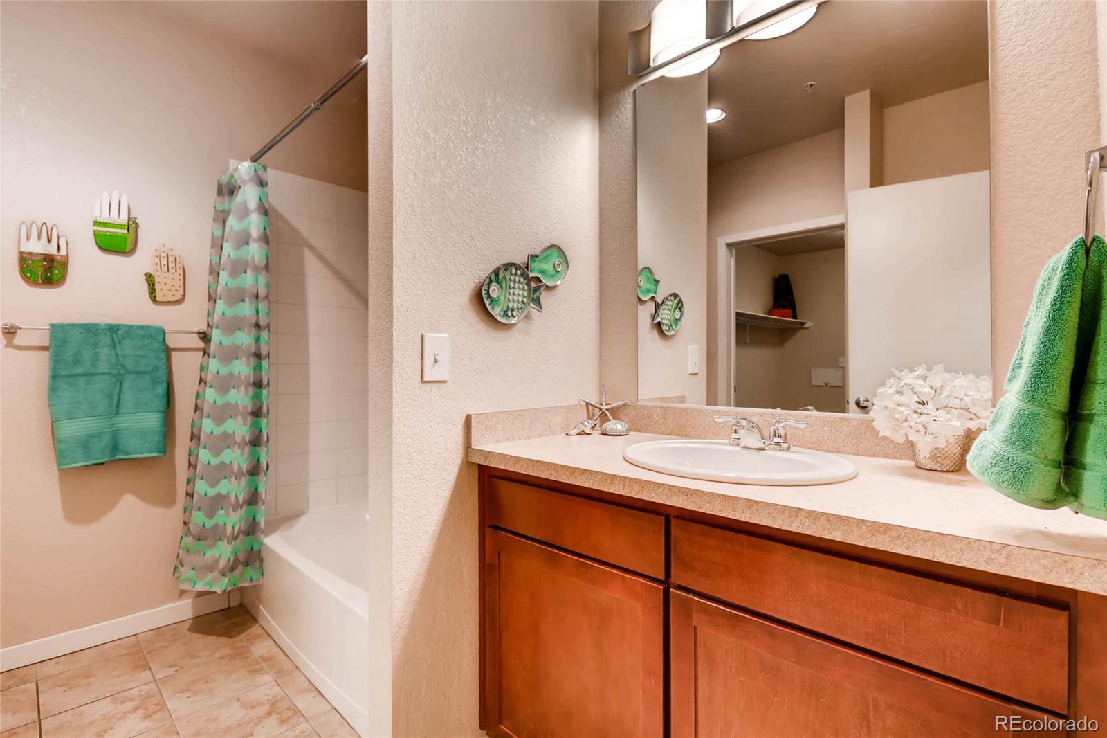 3101 Blake Street, Unit 214 Denver, CO 80205 - Photo 13 of 17 a bathroom with a granite countertop sink and a mirror