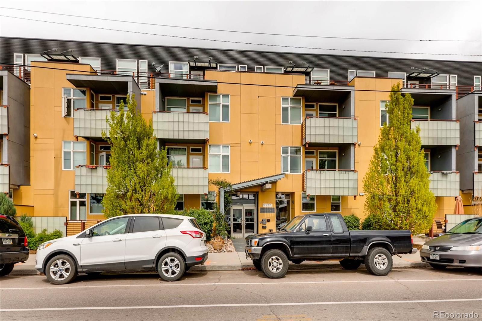 3101 Blake Street, Unit 214 Denver, CO 80205 - Photo 17 of 17 a car parked in front of a building