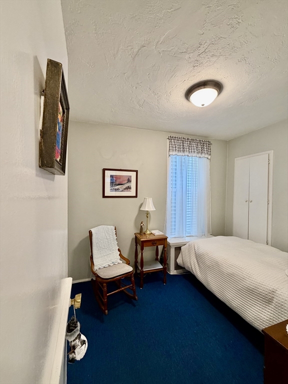 176 M Street, Unit 1 Boston, MA 02127 - Photo 9 of 11 a bedroom with a bed and a chair