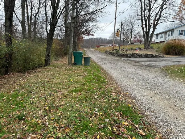 a view of a yard with yellow house