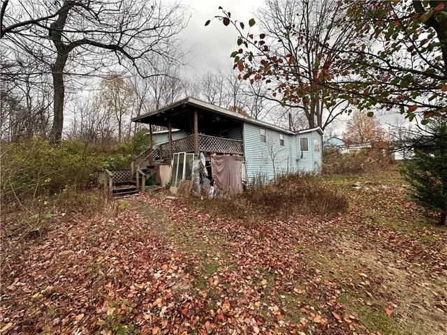 a backyard of a house with table and chairs