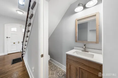 a bathroom with a sink a toilet and a mirror