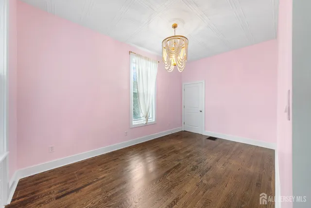a view of a room with wooden floor and window