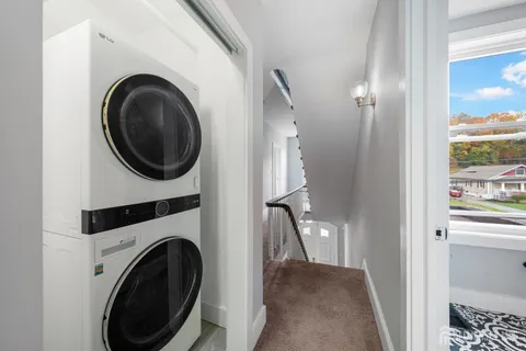 a view of a hallway with washer and dryer