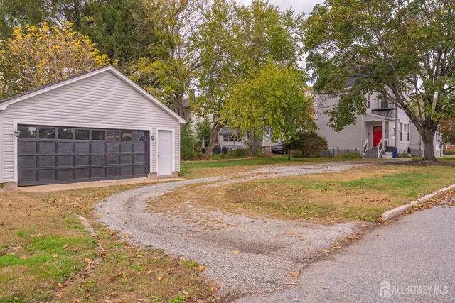 a view of a house with a yard and garage