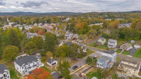 an aerial view of residential houses with outdoor space