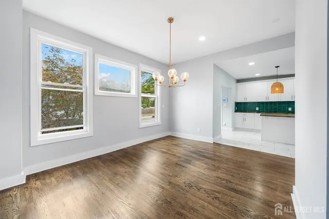 a view of a room with window and wooden floor