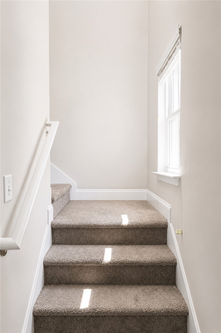 102 Ventura Street Anderson, SC 29621 - Photo 11 of 24 A window-lit staircase with soft carpeting and pristine white trim awaits.