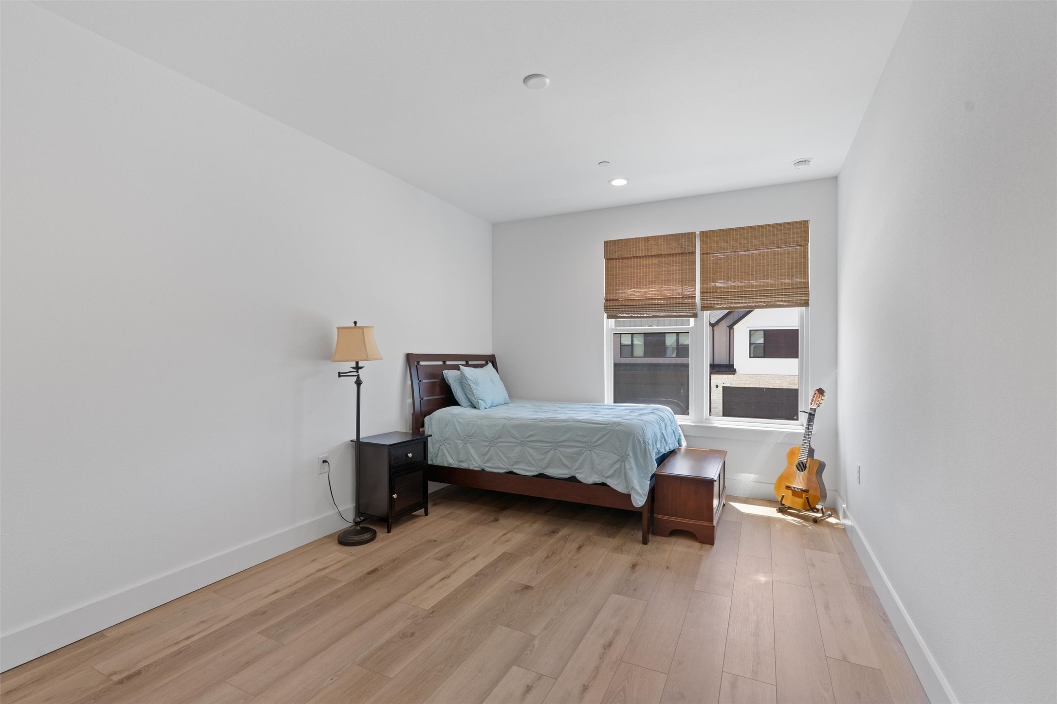 590 Old Mill Road, Unit 153 Cedar Park, TX 78613 - Photo 21 of 40 a room with a bed and a wooden floor