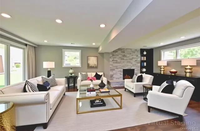 a living room with furniture fireplace and a large window