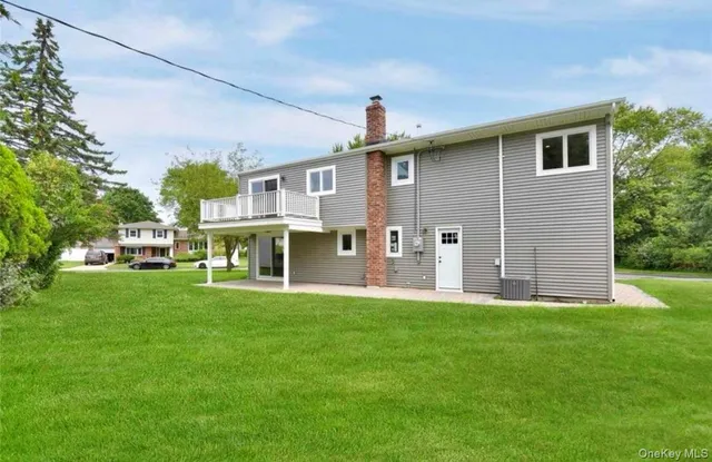 a view of a house with a yard and sitting area
