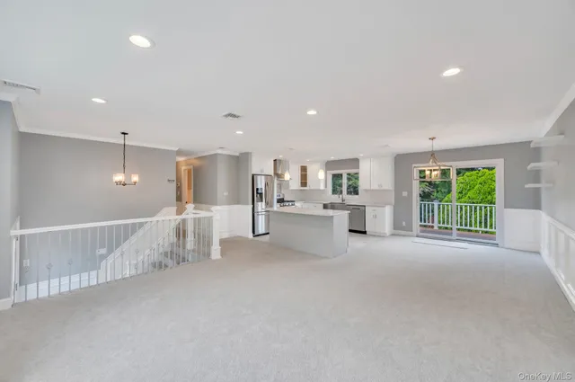 a view of kitchen with furniture and windows