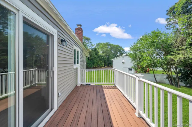 a view of balcony with wooden floor