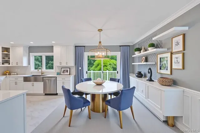 a kitchen with a dining table chairs and white cabinets