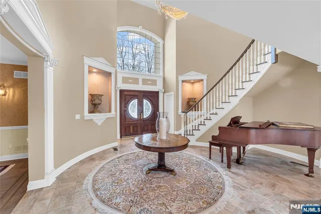a view of a dining room with furniture and chandelier