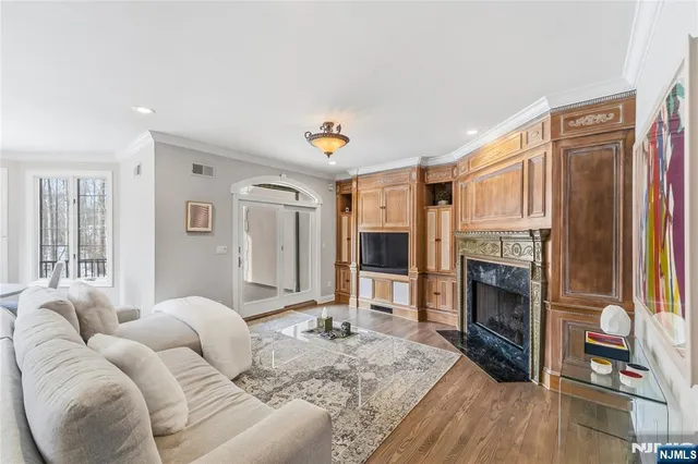 a living room with large window and furniture