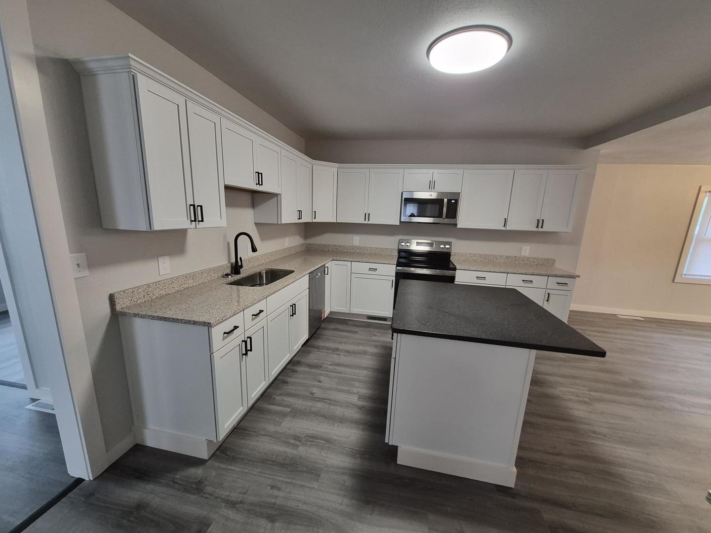 101 North 6th Avenue New Windsor, IL 61465 - Photo 11 of 33 a kitchen with a sink a microwave and cabinets