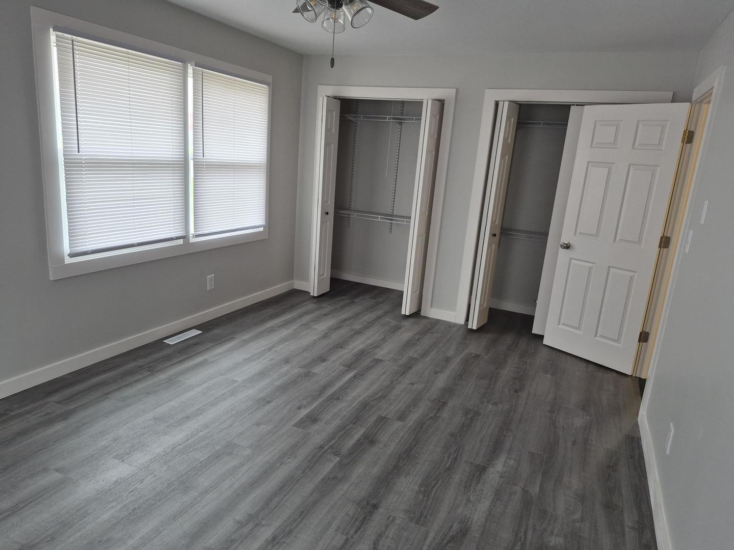 101 North 6th Avenue New Windsor, IL 61465 - Photo 17 of 33 an empty room with wooden floor and windows