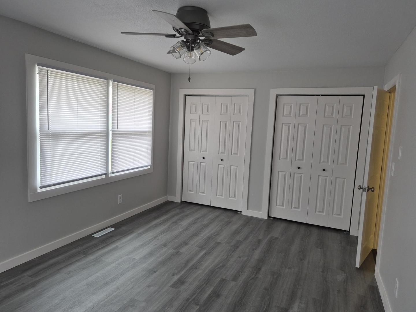 101 North 6th Avenue New Windsor, IL 61465 - Photo 18 of 33 a view of an empty room with a window and wooden floor