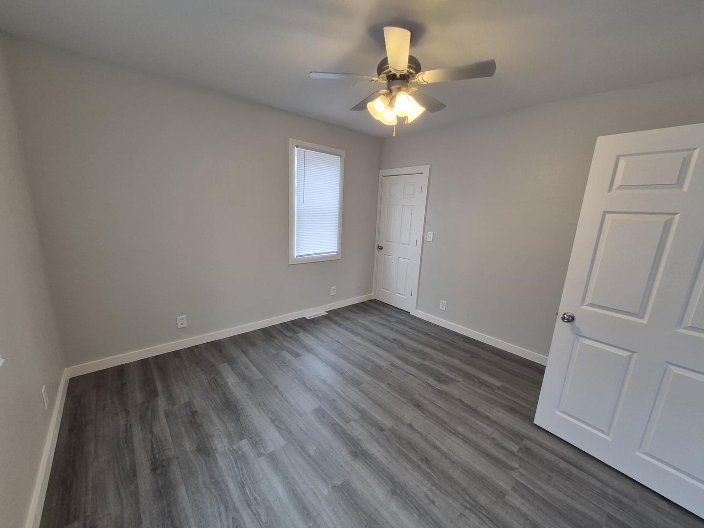 101 North 6th Avenue New Windsor, IL 61465 - Photo 24 of 33 an empty room with wooden floor fan and window