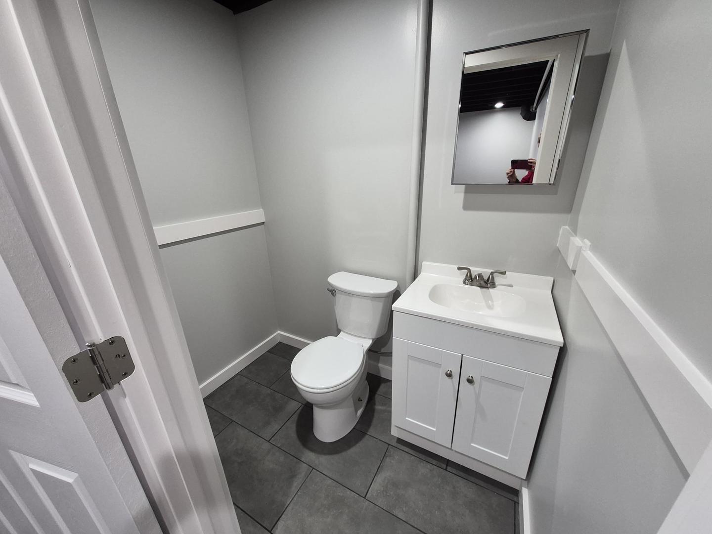101 North 6th Avenue New Windsor, IL 61465 - Photo 29 of 33 a white toilet sitting next to a sink and vanity