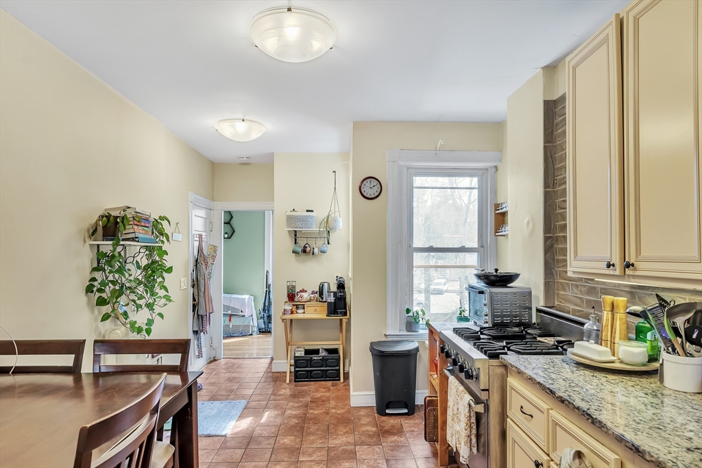 1891 Beacon Street, Unit 2 Brookline, MA 02445 - Photo 13 of 31 a kitchen with granite countertop a stove a sink and a refrigerator