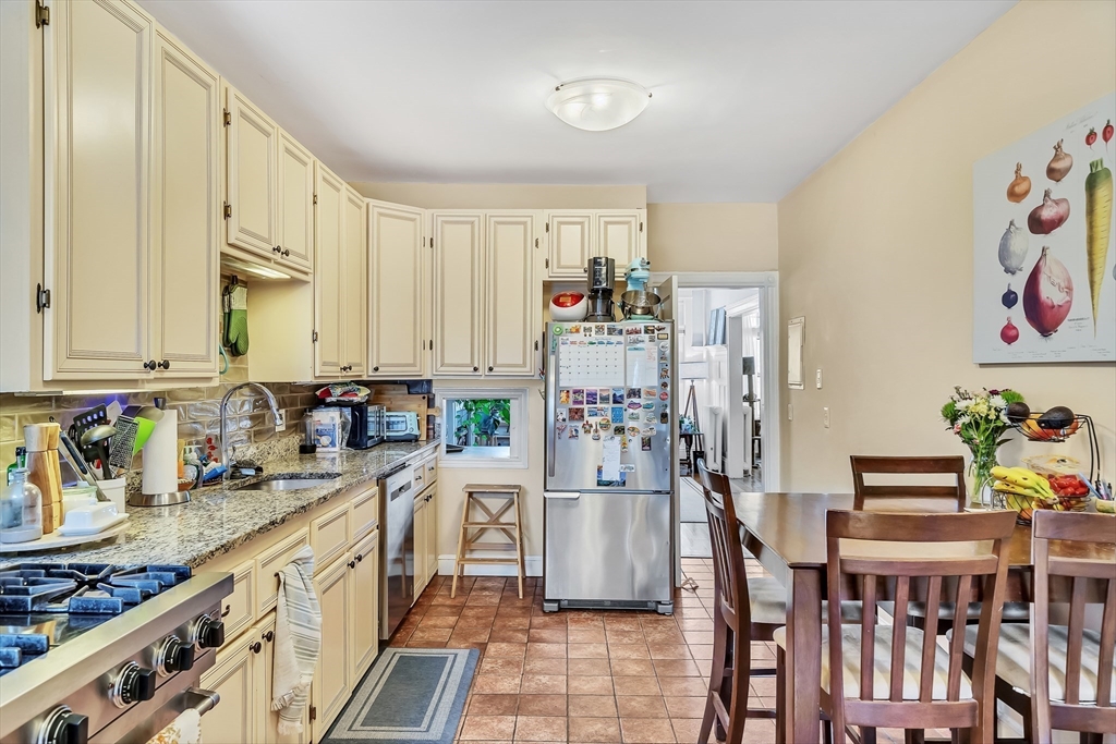 1891 Beacon Street, Unit 2 Brookline, MA 02445 - Photo 15 of 31 a kitchen with stainless steel appliances granite countertop a stove a sink dishwasher and cabinets with wooden floor