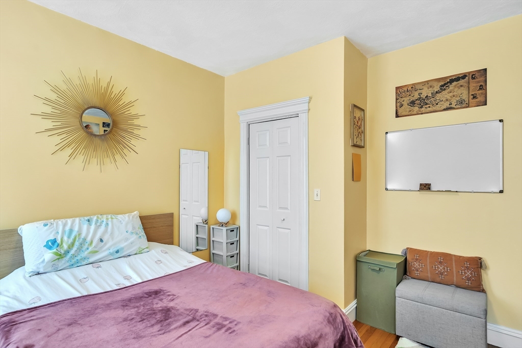 1891 Beacon Street, Unit 2 Brookline, MA 02445 - Photo 19 of 31 a bedroom with a bed and a couch