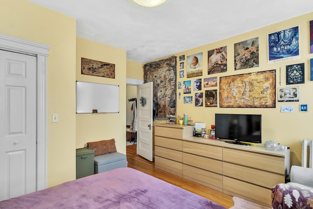 1891 Beacon Street, Unit 2 Brookline, MA 02445 - Photo 20 of 31 a bedroom with a bed and wooden floor