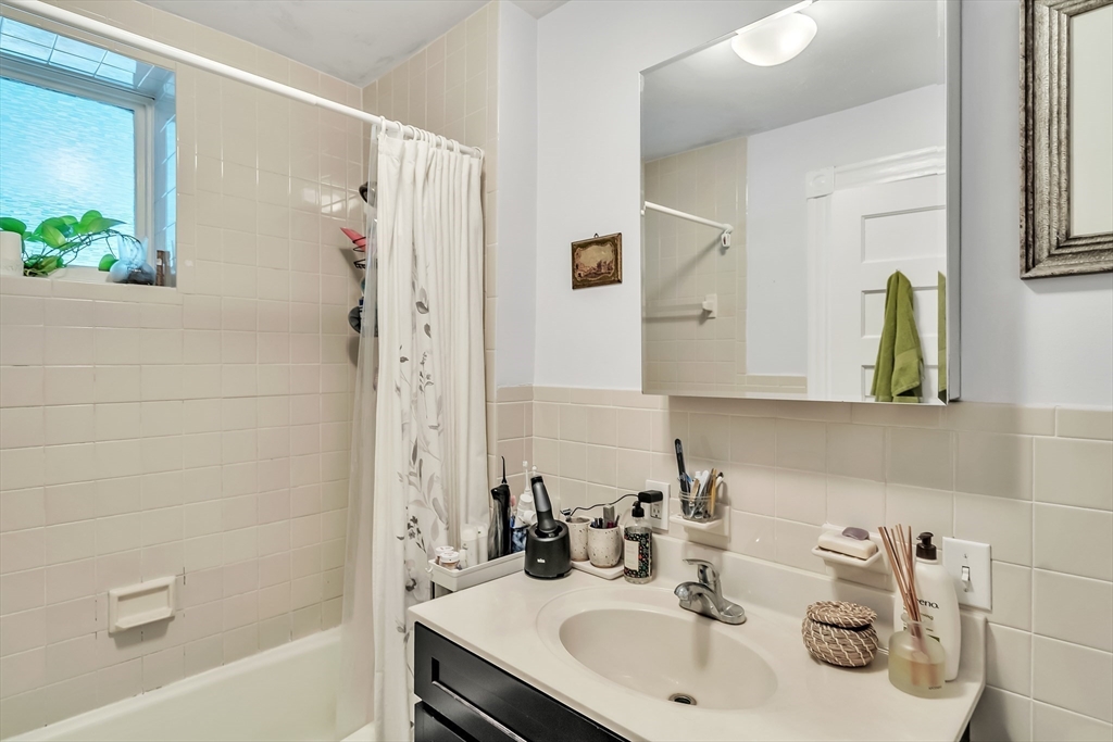 1891 Beacon Street, Unit 2 Brookline, MA 02445 - Photo 27 of 31 a bathroom with a sink and a bathtub