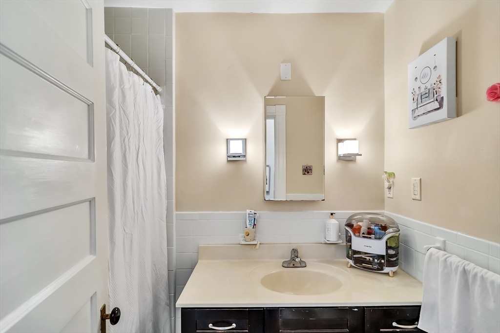 1891 Beacon Street, Unit 2 Brookline, MA 02445 - Photo 28 of 31 a bathroom with a sink and a mirror