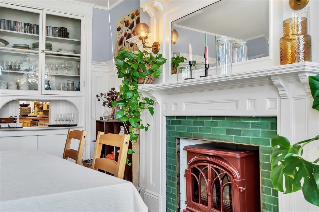 1891 Beacon Street, Unit 2 Brookline, MA 02445 - Photo 7 of 31 a utility room with furniture a potted plant and a fireplace
