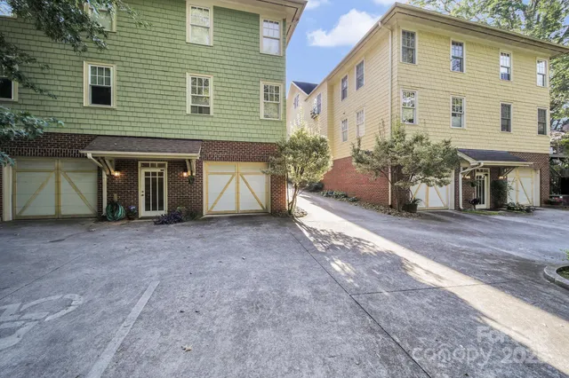 a view of a house with a tree in front of it