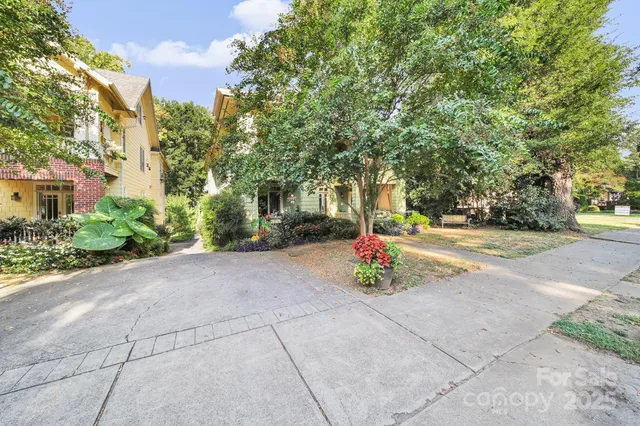 a view of house with a swimming pool and sitting area
