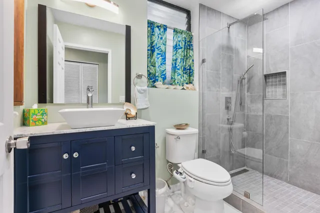 a bathroom with a toilet and shower