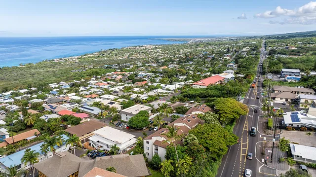 an aerial view of multiple houses with a yard